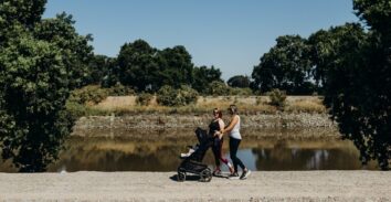 Mothers walking with child in stroller along river in Lathrop, CA