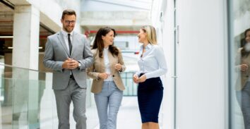 Young professionals walking through a building hallway